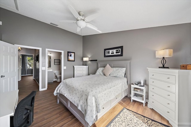 bedroom featuring lofted ceiling, hardwood / wood-style floors, ensuite bath, and ceiling fan