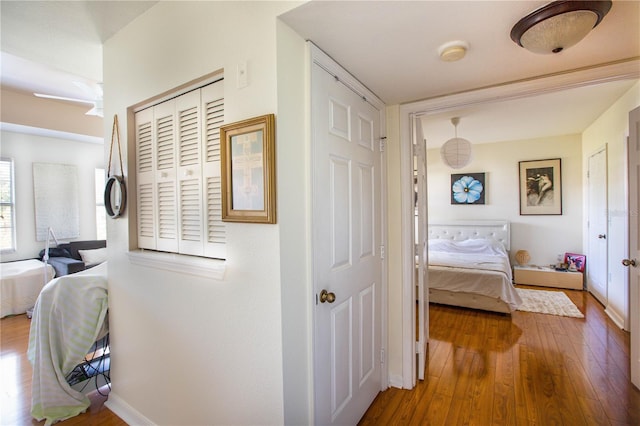 corridor with hardwood / wood-style flooring