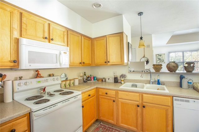 kitchen with white appliances, sink, and hanging light fixtures