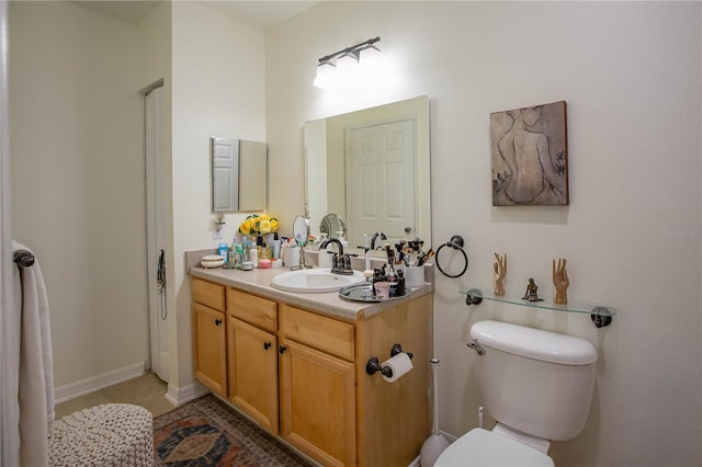 bathroom featuring vanity, toilet, and tile patterned floors