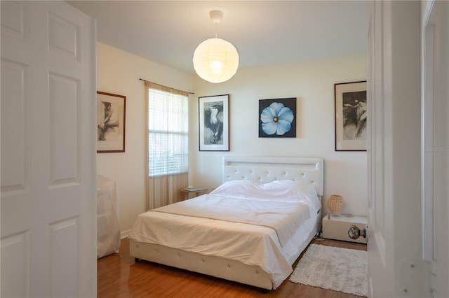 bedroom with wood-type flooring