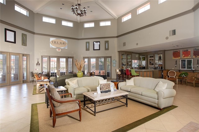 interior space with an inviting chandelier, french doors, beam ceiling, and a high ceiling