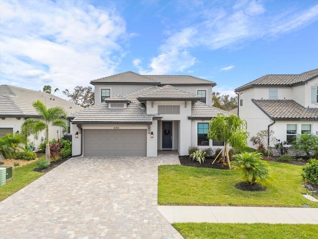 view of front of property featuring a garage and a front yard