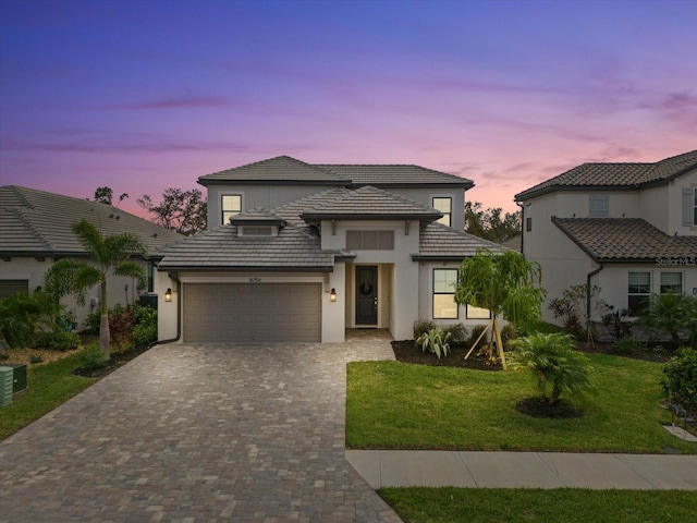 view of front of home with a lawn and a garage