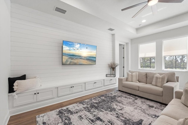 living room featuring dark hardwood / wood-style floors and ceiling fan