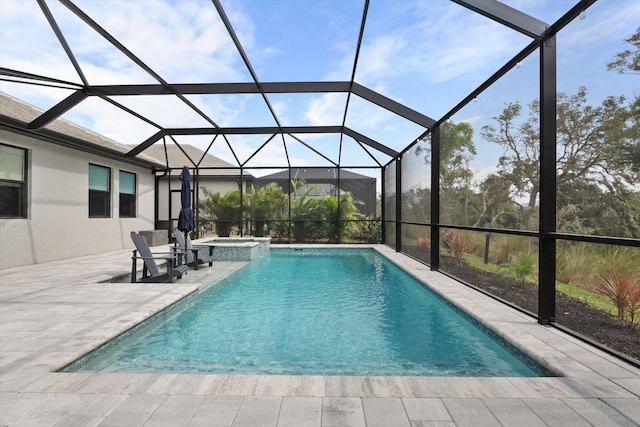 view of swimming pool featuring a patio, glass enclosure, and an in ground hot tub