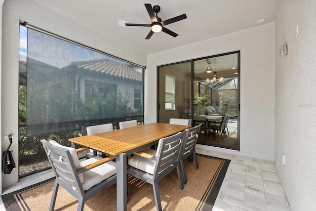 interior space featuring ceiling fan with notable chandelier