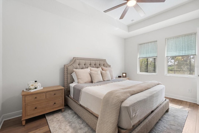 bedroom with ceiling fan and light hardwood / wood-style floors