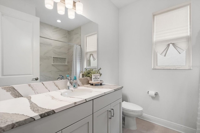 bathroom with walk in shower, vanity, toilet, and tile patterned floors