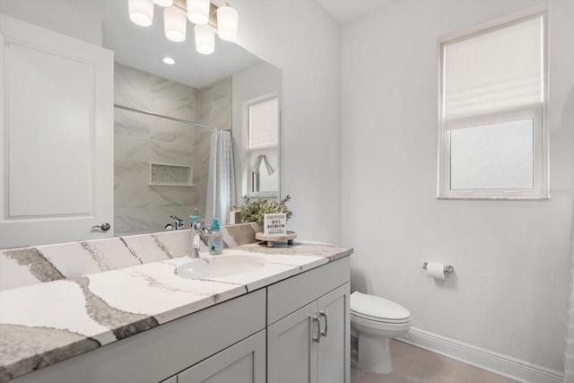 bathroom with curtained shower, vanity, and toilet