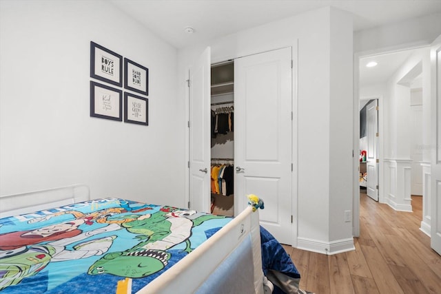 bedroom with a closet and light hardwood / wood-style floors