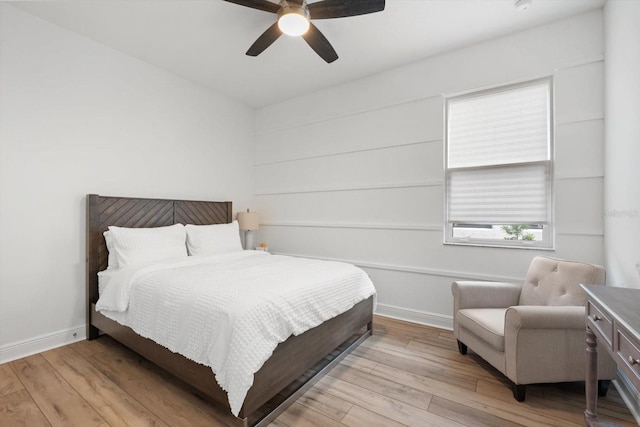 bedroom with ceiling fan and light hardwood / wood-style flooring