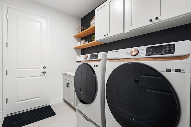 laundry room with cabinets and separate washer and dryer