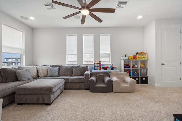 carpeted living room featuring ceiling fan