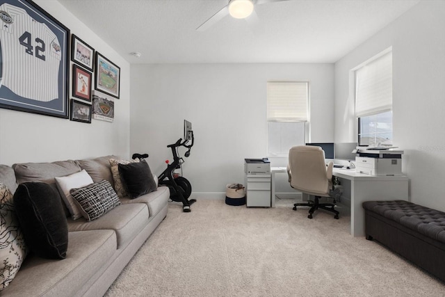 carpeted home office with ceiling fan