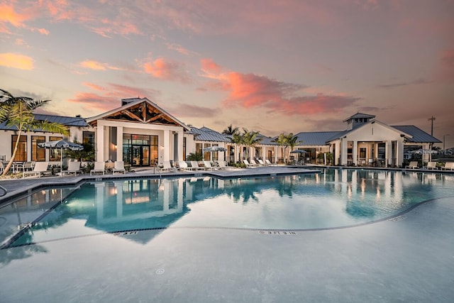 pool at dusk featuring a patio area