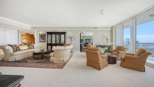 carpeted living room with ornamental molding