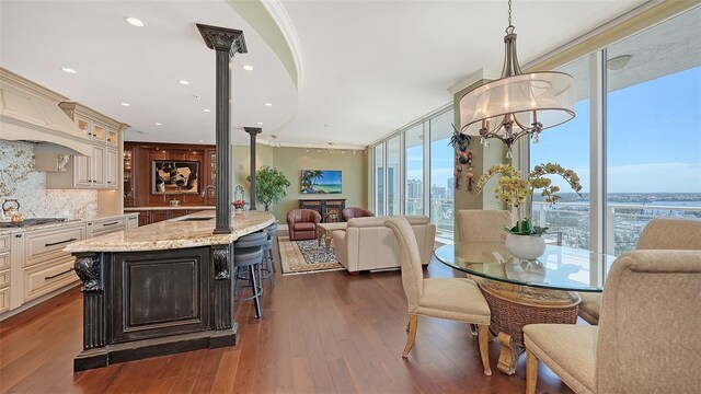 dining area with a chandelier, sink, dark hardwood / wood-style floors, and plenty of natural light