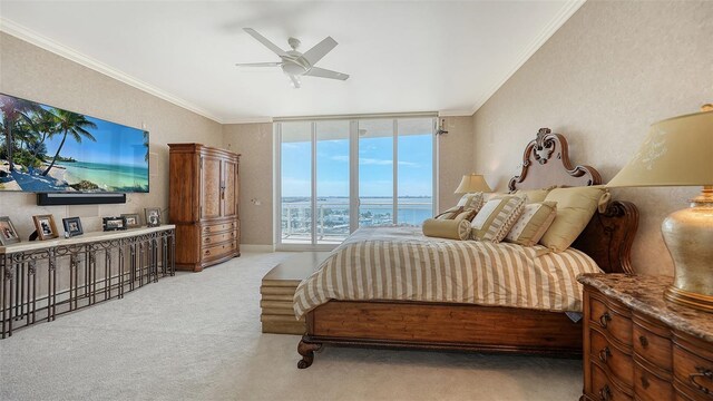 bedroom with ornamental molding, light colored carpet, a water view, and ceiling fan