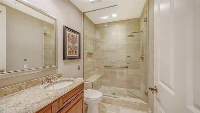 bathroom with vanity, toilet, and an enclosed shower