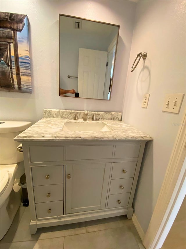 bathroom with tile patterned floors, vanity, and toilet