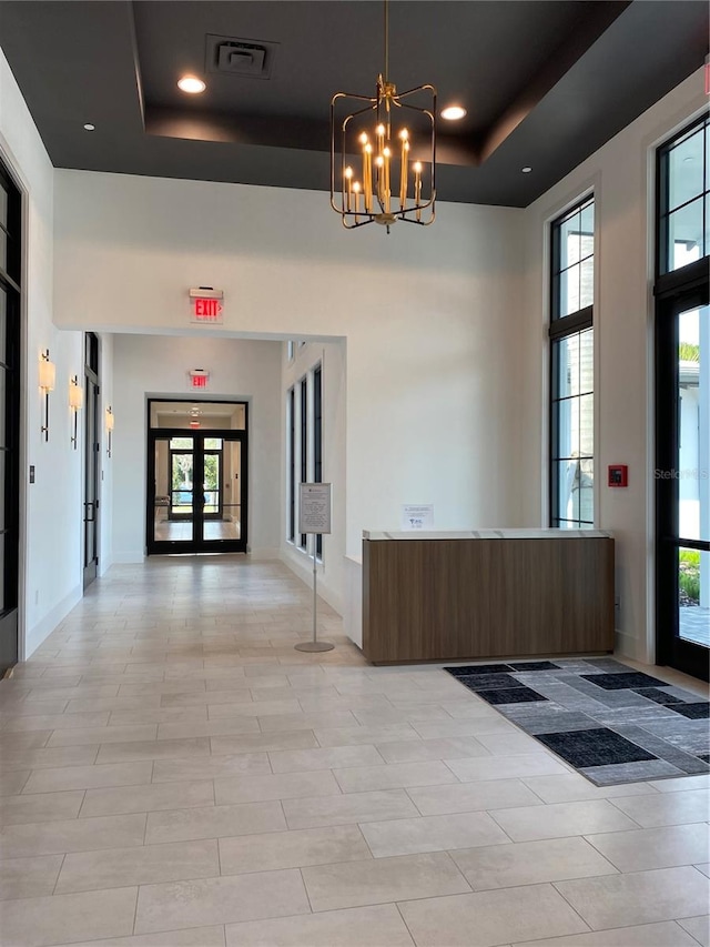 reception with a chandelier and french doors