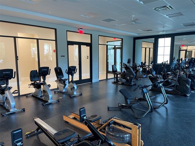 exercise room featuring a paneled ceiling and ceiling fan