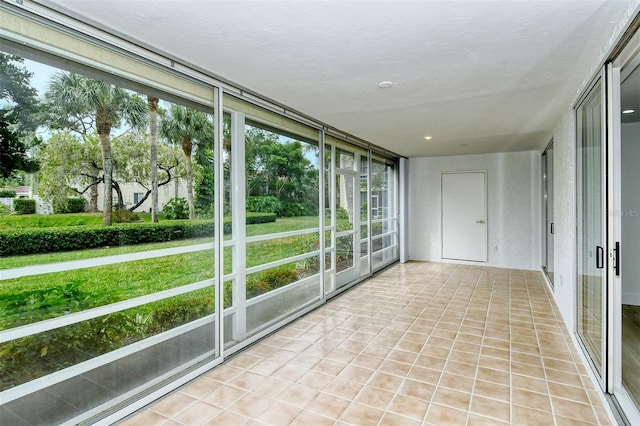 unfurnished sunroom with tile patterned floors
