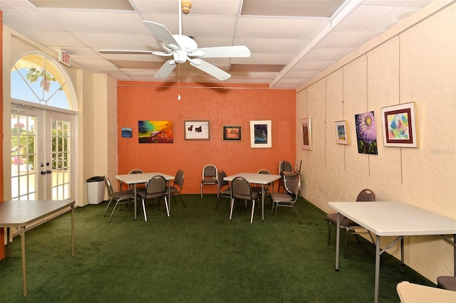 dining area featuring french doors, ceiling fan, and dark colored carpet