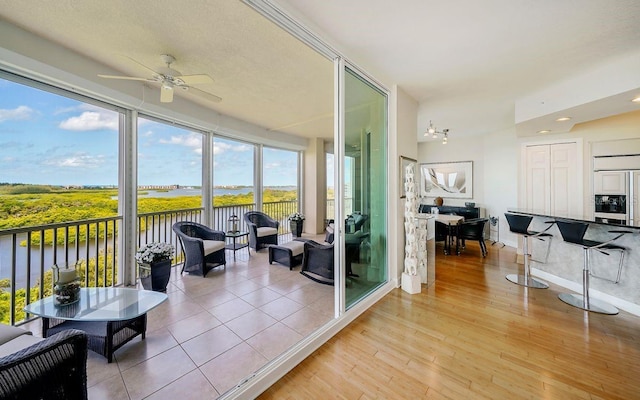 sunroom / solarium with a water view