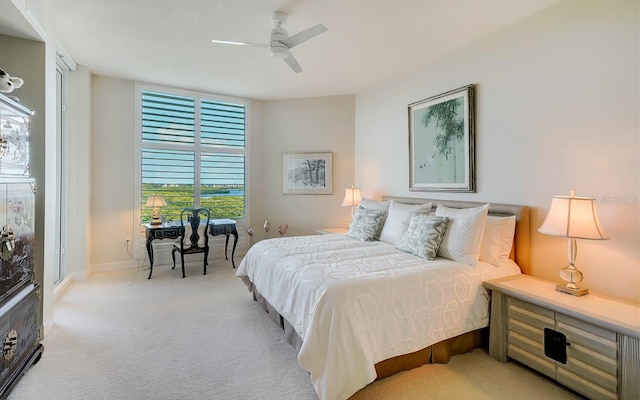 bedroom with ceiling fan and light colored carpet