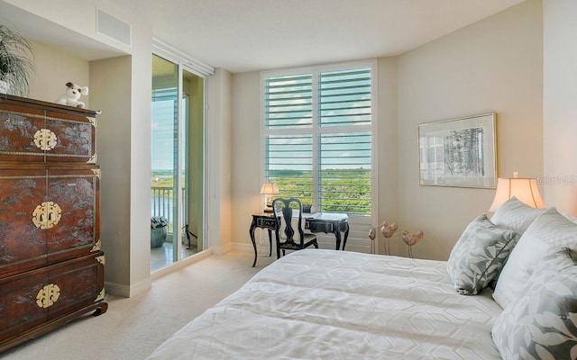 bedroom with baseboards, visible vents, and carpet
