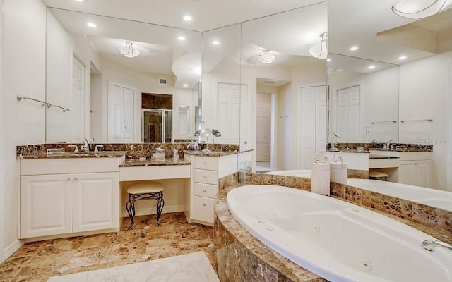 bathroom featuring vanity, recessed lighting, a jetted tub, and a stall shower