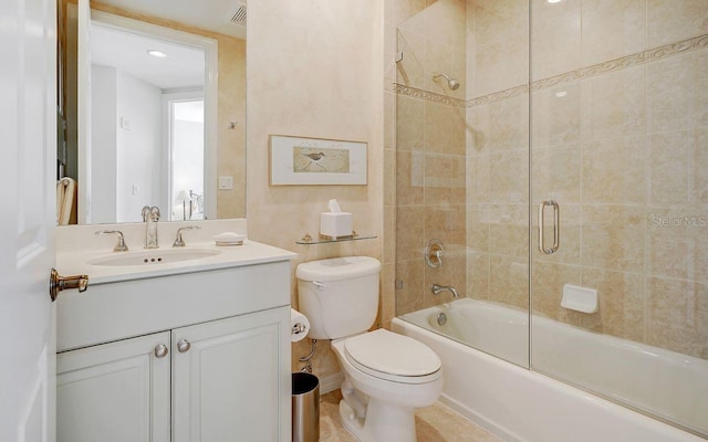 full bath with vanity, combined bath / shower with glass door, toilet, and visible vents