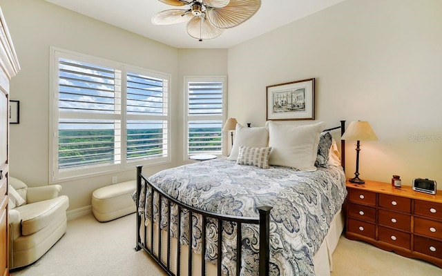 carpeted bedroom with multiple windows and ceiling fan