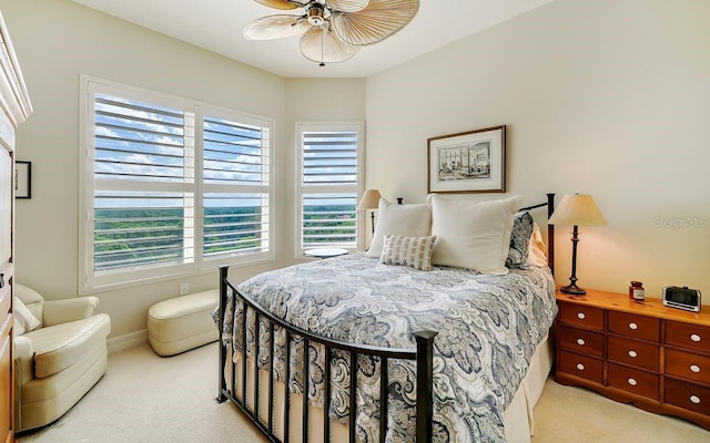 bedroom featuring baseboards, multiple windows, and carpet flooring