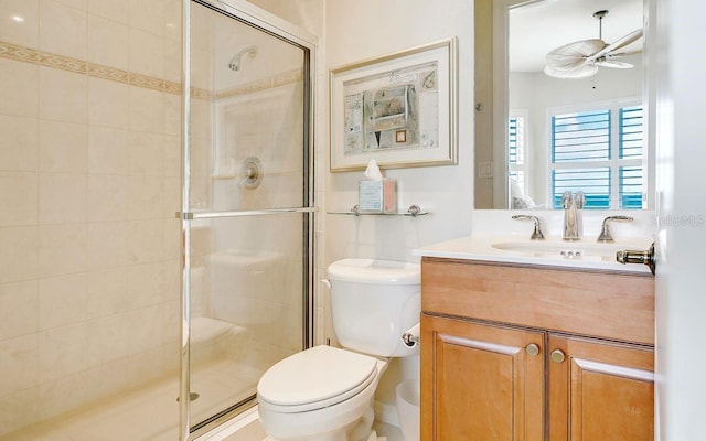 full bath with vanity, ceiling fan, a stall shower, and toilet