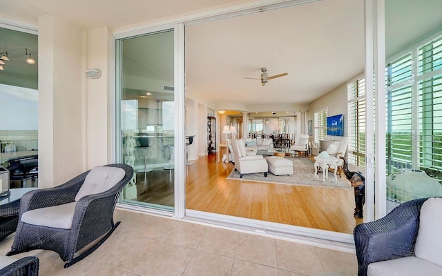 interior space featuring tile patterned flooring and a ceiling fan