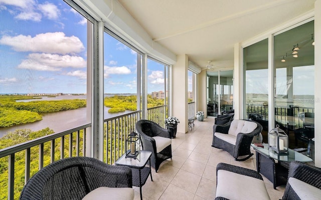 sunroom featuring a water view