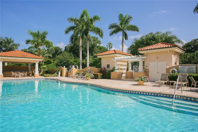 community pool featuring a pergola, a gazebo, and a patio area