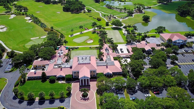 birds eye view of property with a water view and view of golf course