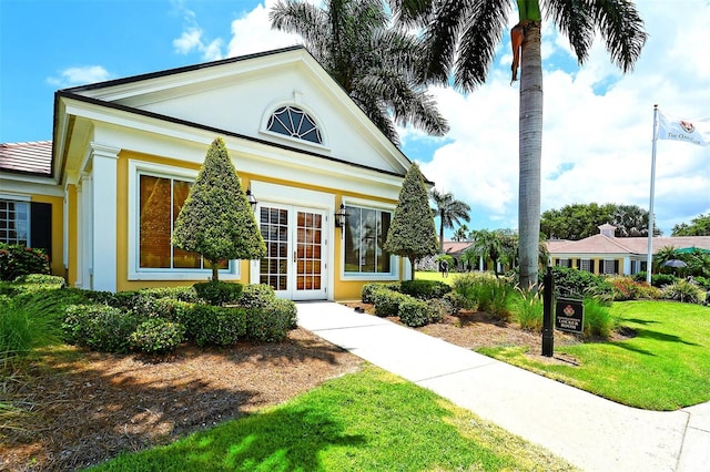 view of front of property with stucco siding and a front lawn
