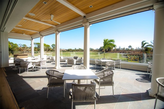 view of patio with outdoor lounge area, a water view, view of golf course, and outdoor dining space