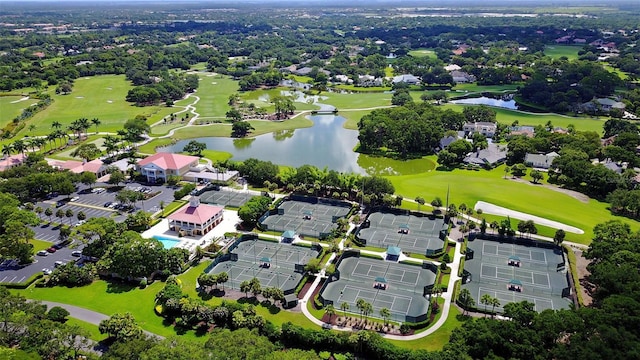 drone / aerial view with view of golf course and a water view