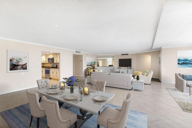 tiled dining area featuring ornamental molding