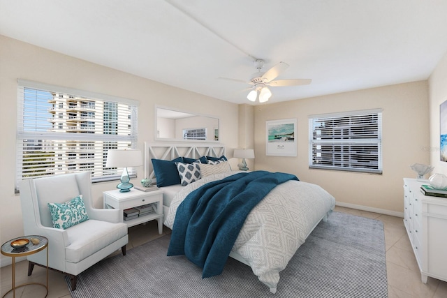 tiled bedroom featuring ceiling fan