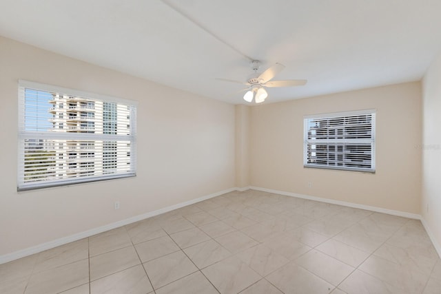 tiled spare room featuring ceiling fan