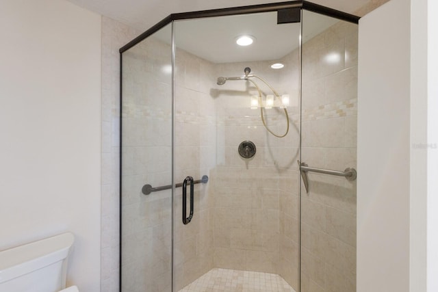 bathroom with toilet and walk in shower