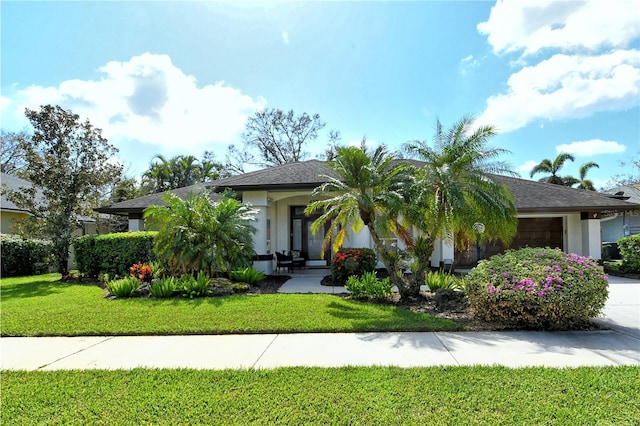 view of front of home with a front lawn and a garage