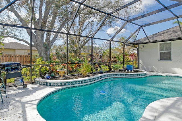 view of swimming pool with a patio area, grilling area, and glass enclosure